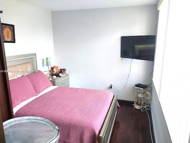 bedroom with dark wood-type flooring