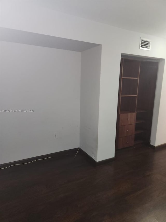 spare room featuring dark hardwood / wood-style floors