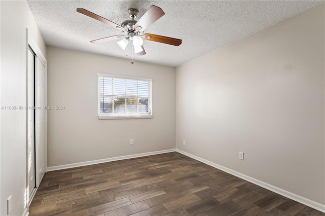 unfurnished bedroom featuring ceiling fan, dark hardwood / wood-style flooring, and a textured ceiling