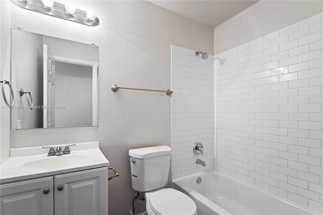 full bathroom with vanity, tiled shower / bath combo, and toilet