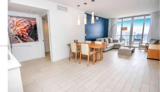 interior space with floor to ceiling windows and light wood-type flooring