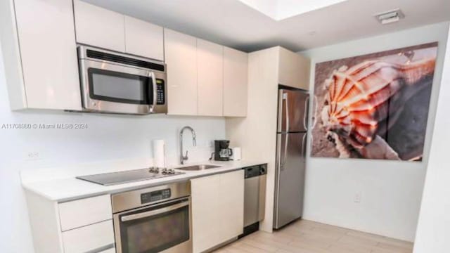 kitchen with white cabinetry, sink, and appliances with stainless steel finishes