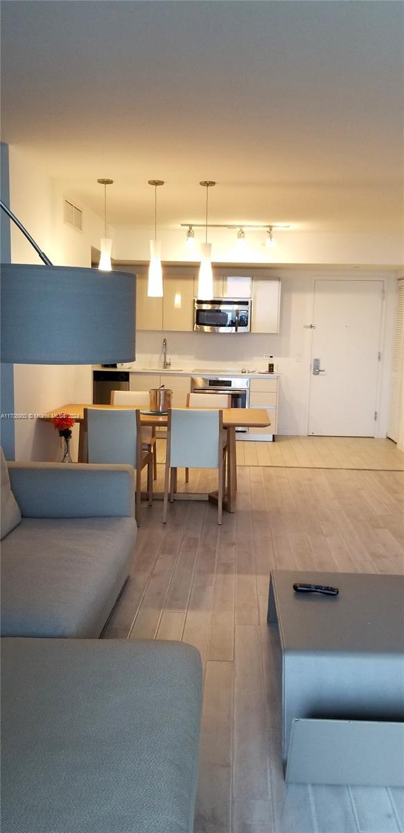 living room with sink and wood-type flooring