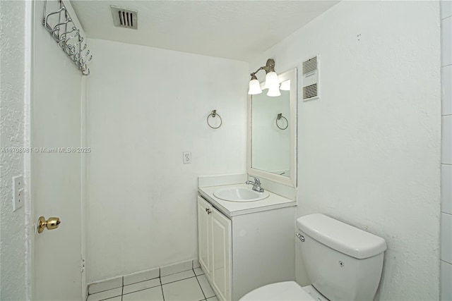 bathroom with tile patterned floors, vanity, and toilet