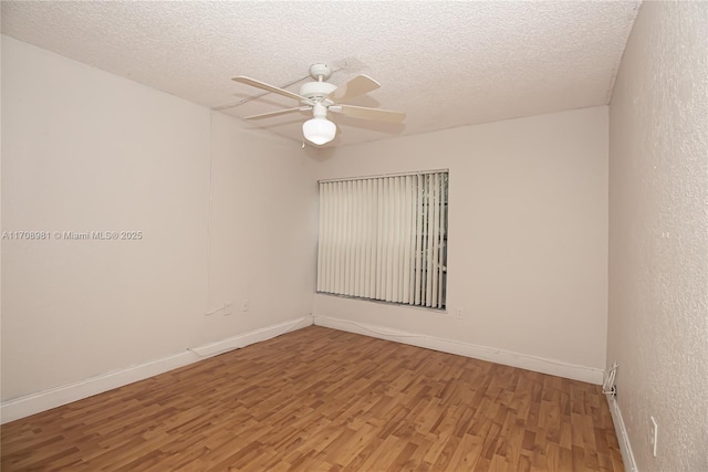 spare room featuring hardwood / wood-style floors, a textured ceiling, and ceiling fan