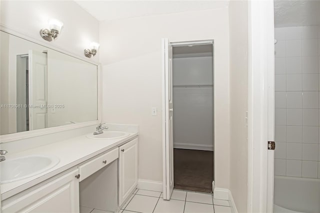 bathroom featuring vanity, tile patterned floors, and tiled shower / bath