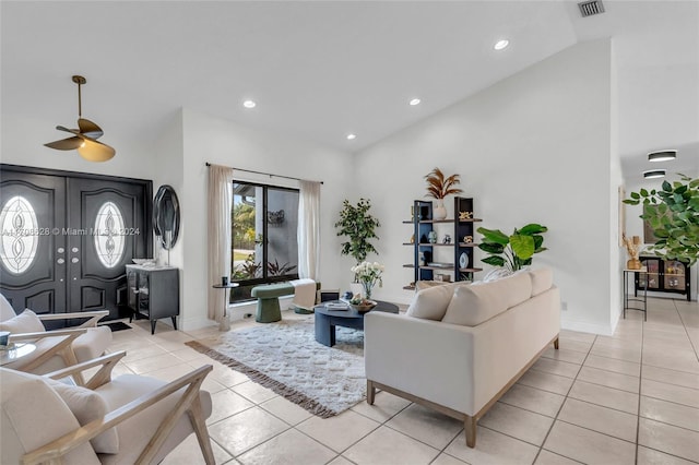 tiled living room featuring ceiling fan and high vaulted ceiling