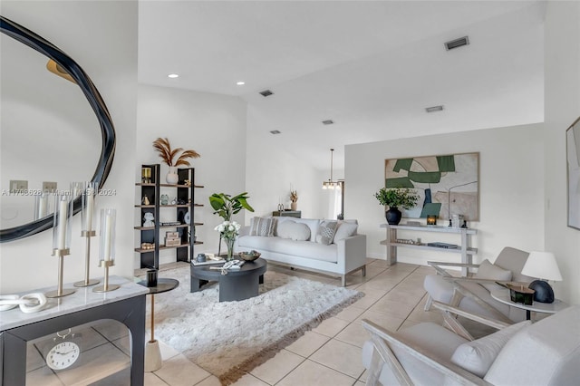 living room with a notable chandelier, light tile patterned floors, and lofted ceiling