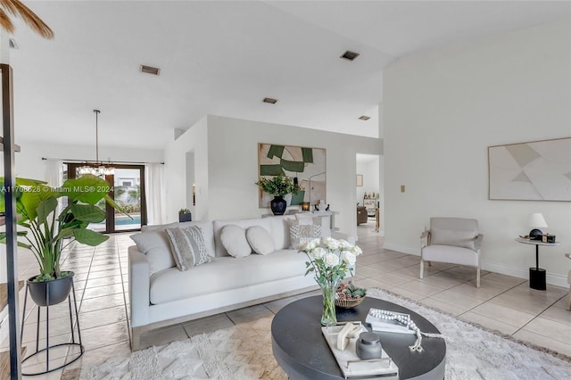 tiled living room featuring a notable chandelier