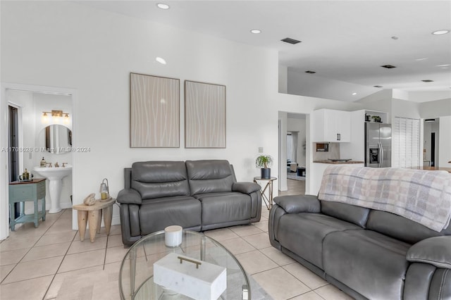 living room with light tile patterned flooring and sink