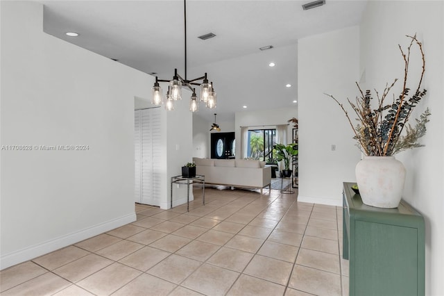 interior space with a notable chandelier and light tile patterned flooring