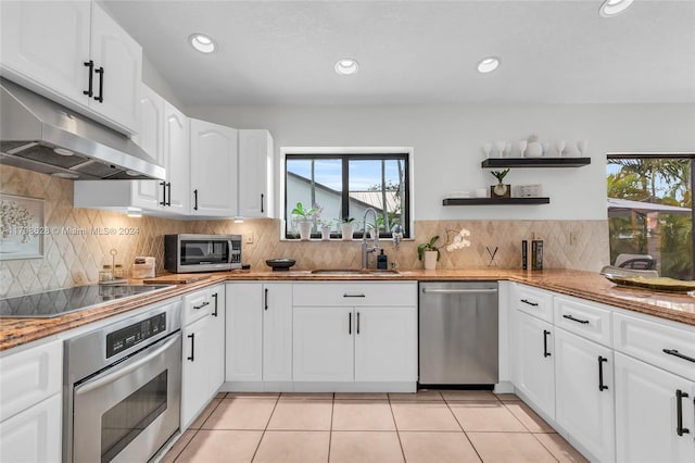 kitchen featuring a healthy amount of sunlight, sink, white cabinetry, and stainless steel appliances