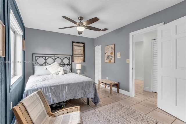 tiled bedroom with ceiling fan