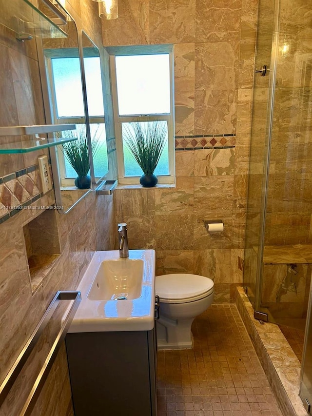 bathroom with vanity, toilet, an enclosed shower, and tile walls