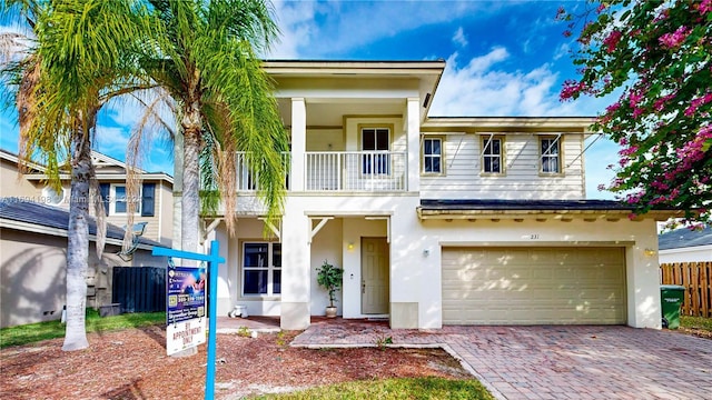 view of front facade with a balcony and a garage