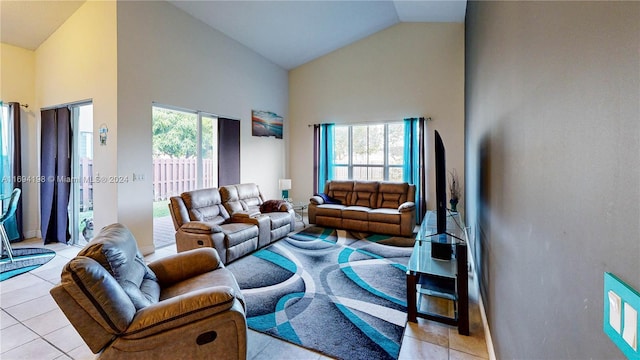 living room with high vaulted ceiling and light tile patterned flooring