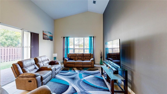 living room with plenty of natural light and high vaulted ceiling