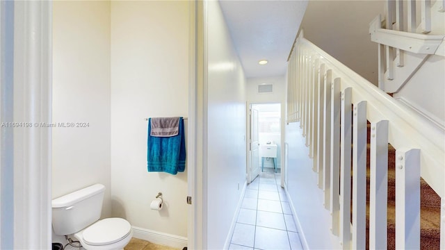 bathroom with tile patterned flooring and toilet