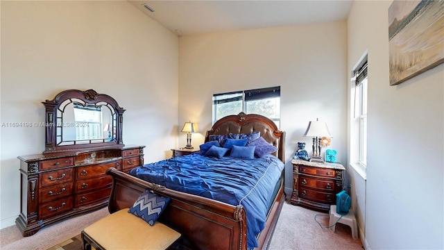 carpeted bedroom with vaulted ceiling