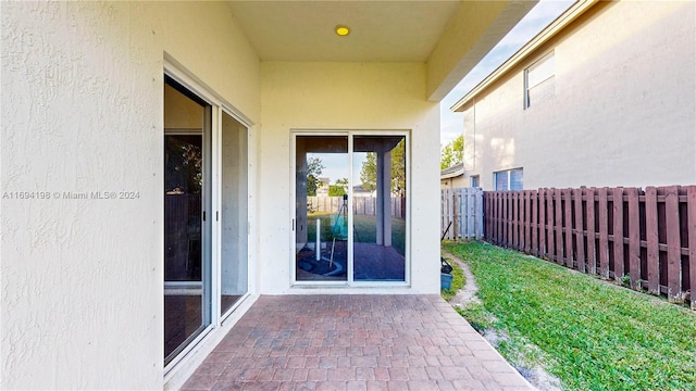 view of exterior entry featuring a patio