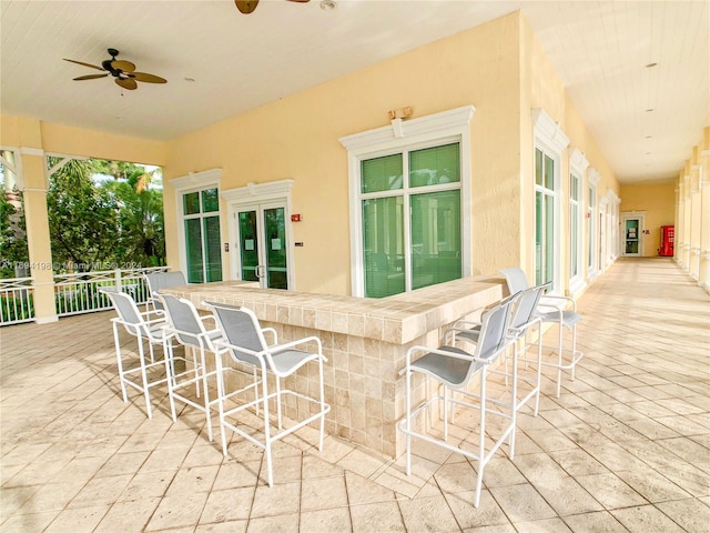 view of patio with an outdoor bar and ceiling fan