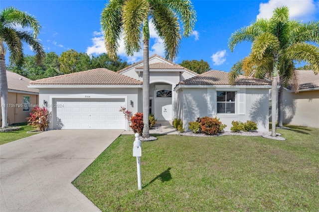 mediterranean / spanish-style home with a garage and a front lawn