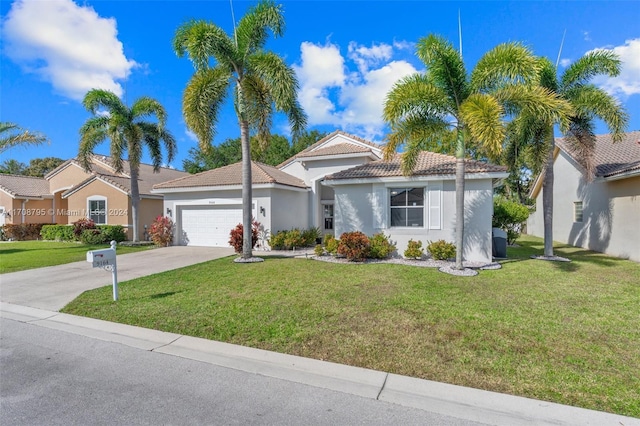 view of front of property featuring a front yard and a garage