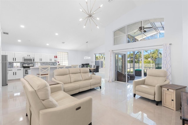 living room featuring ceiling fan with notable chandelier, high vaulted ceiling, and a healthy amount of sunlight