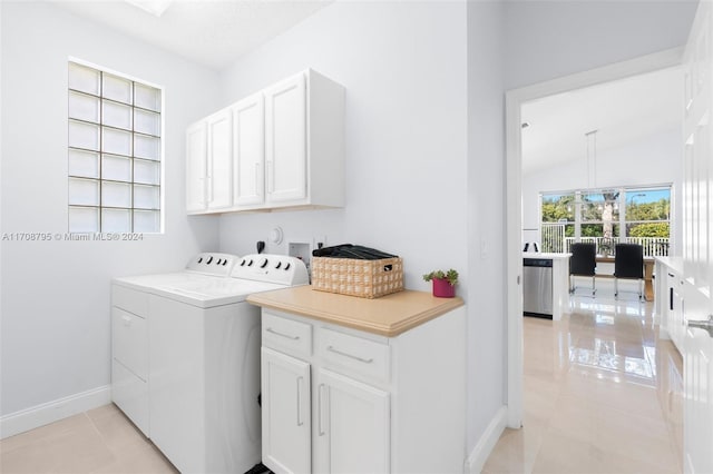 laundry room with separate washer and dryer, light tile patterned floors, and cabinets