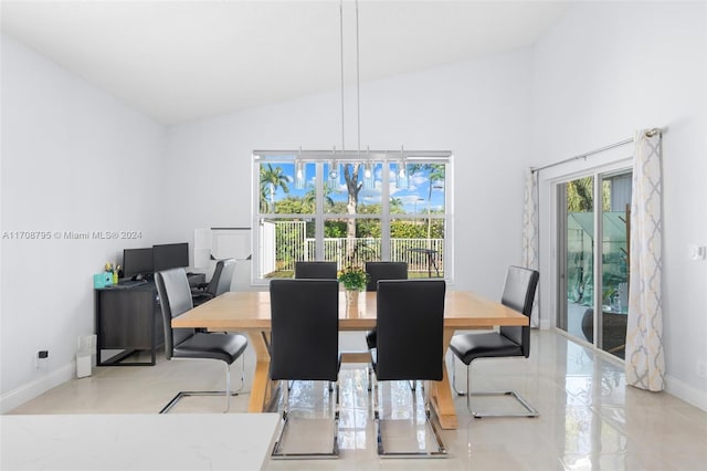 dining room with high vaulted ceiling and an inviting chandelier