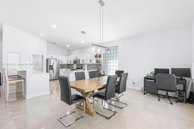 tiled dining space with lofted ceiling