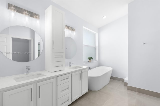 bathroom featuring a tub to relax in, tile patterned flooring, and vanity