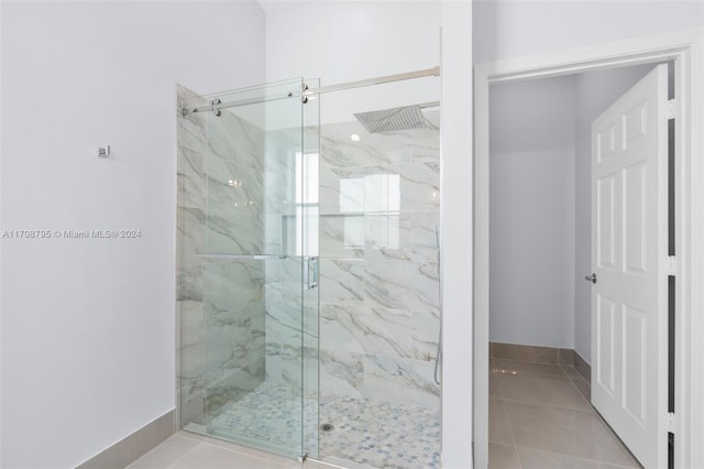 bathroom with tile patterned floors and an enclosed shower