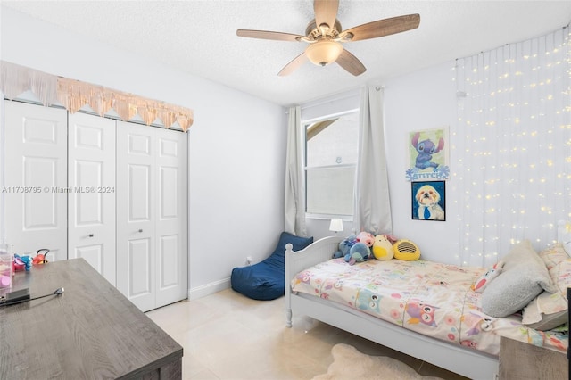 bedroom featuring a textured ceiling, a closet, and ceiling fan