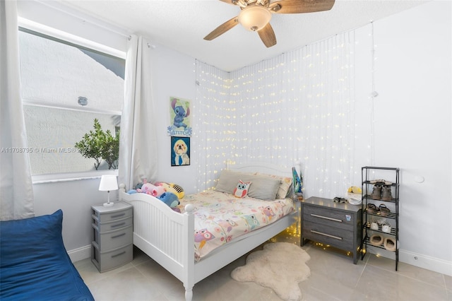 tiled bedroom featuring ceiling fan