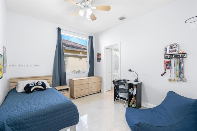 bedroom with a textured ceiling and ceiling fan