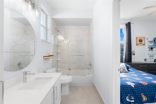 full bathroom with tile patterned floors, bath / shower combo with glass door, vanity, ceiling fan, and toilet