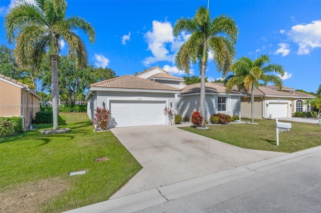 view of front of house featuring a front lawn and a garage