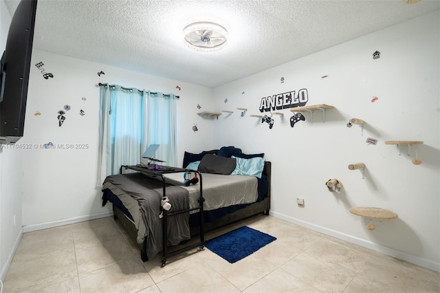 tiled bedroom featuring a textured ceiling