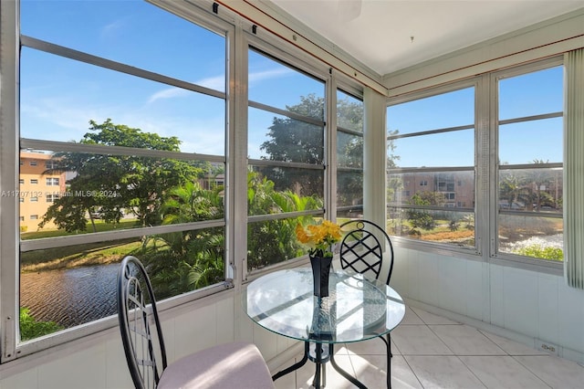 sunroom with a wealth of natural light and a water view