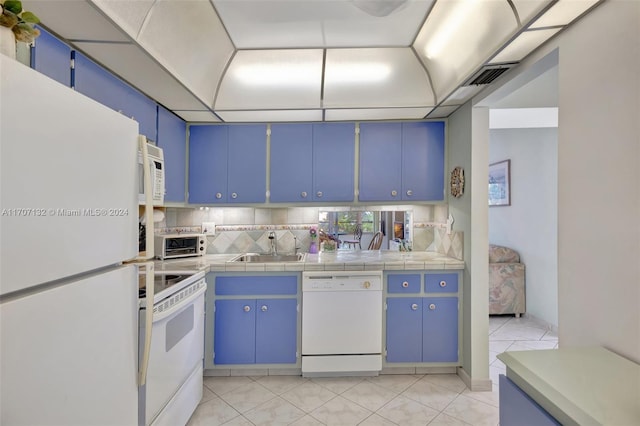 kitchen featuring white appliances and blue cabinetry