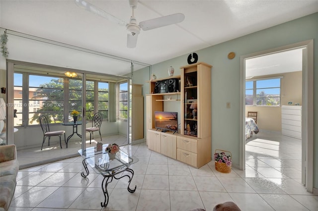 tiled living room with ceiling fan