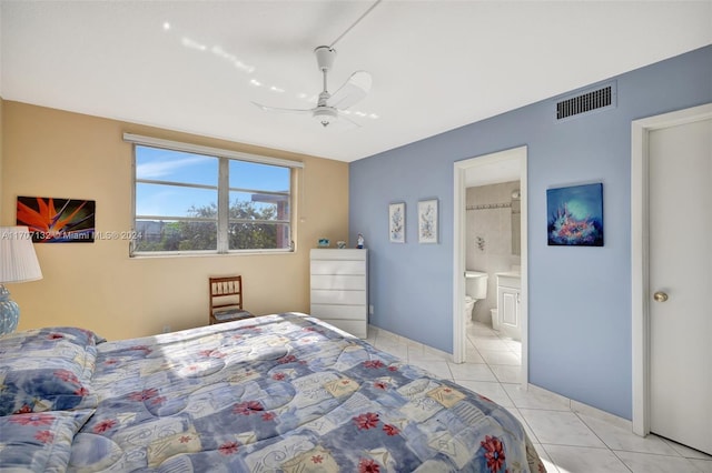 bedroom featuring light tile patterned floors, ensuite bathroom, and ceiling fan