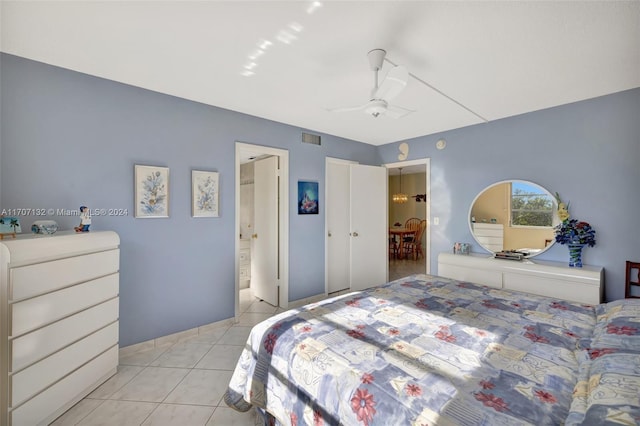 bedroom with ceiling fan and light tile patterned flooring