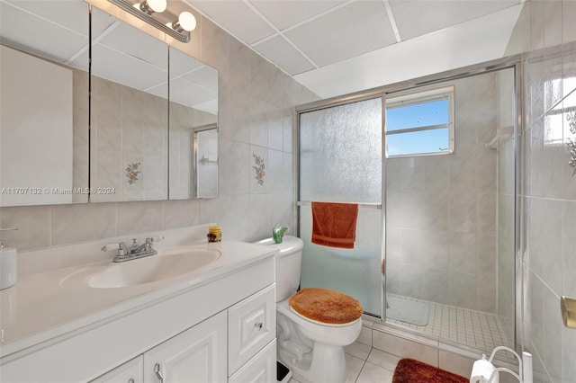 2900 NW 47th Ter Unit 310A, Lauderdale Lakes, FL 33313 - bathroom with vanity, a shower stall, tile patterned flooring, and tile walls
