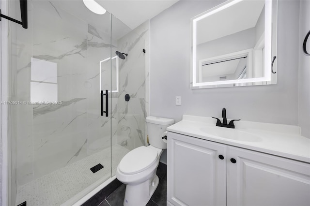 bathroom with walk in shower, tile patterned floors, vanity, and toilet