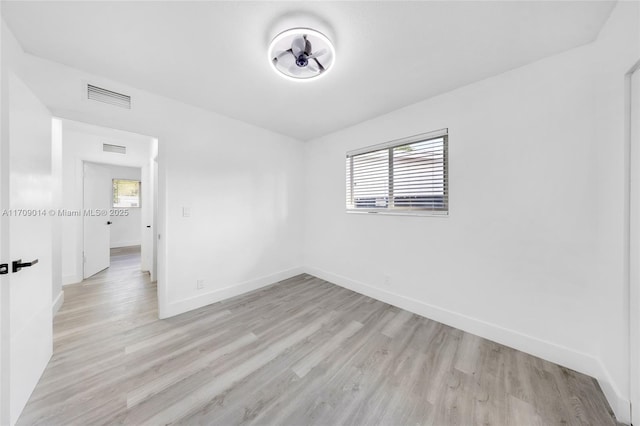 unfurnished room featuring plenty of natural light and light wood-type flooring