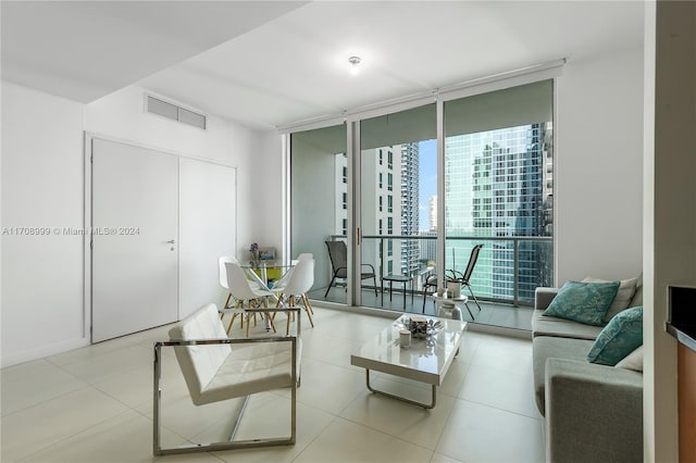 living room featuring light tile patterned floors and expansive windows