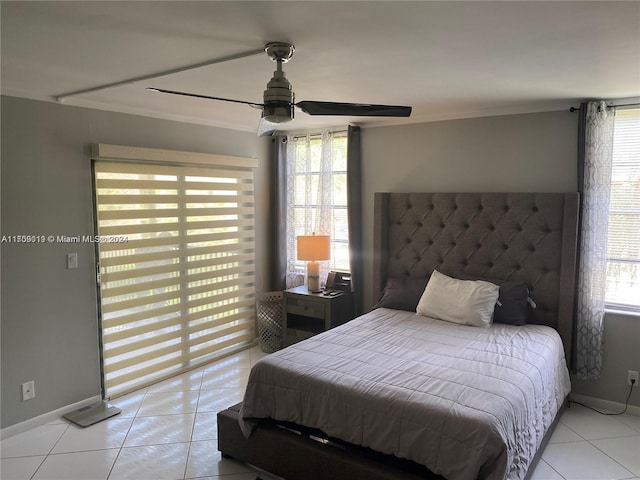 tiled bedroom with ceiling fan and crown molding