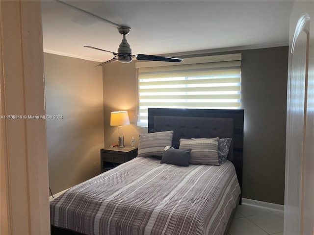 bedroom with ceiling fan, ornamental molding, and light tile patterned flooring